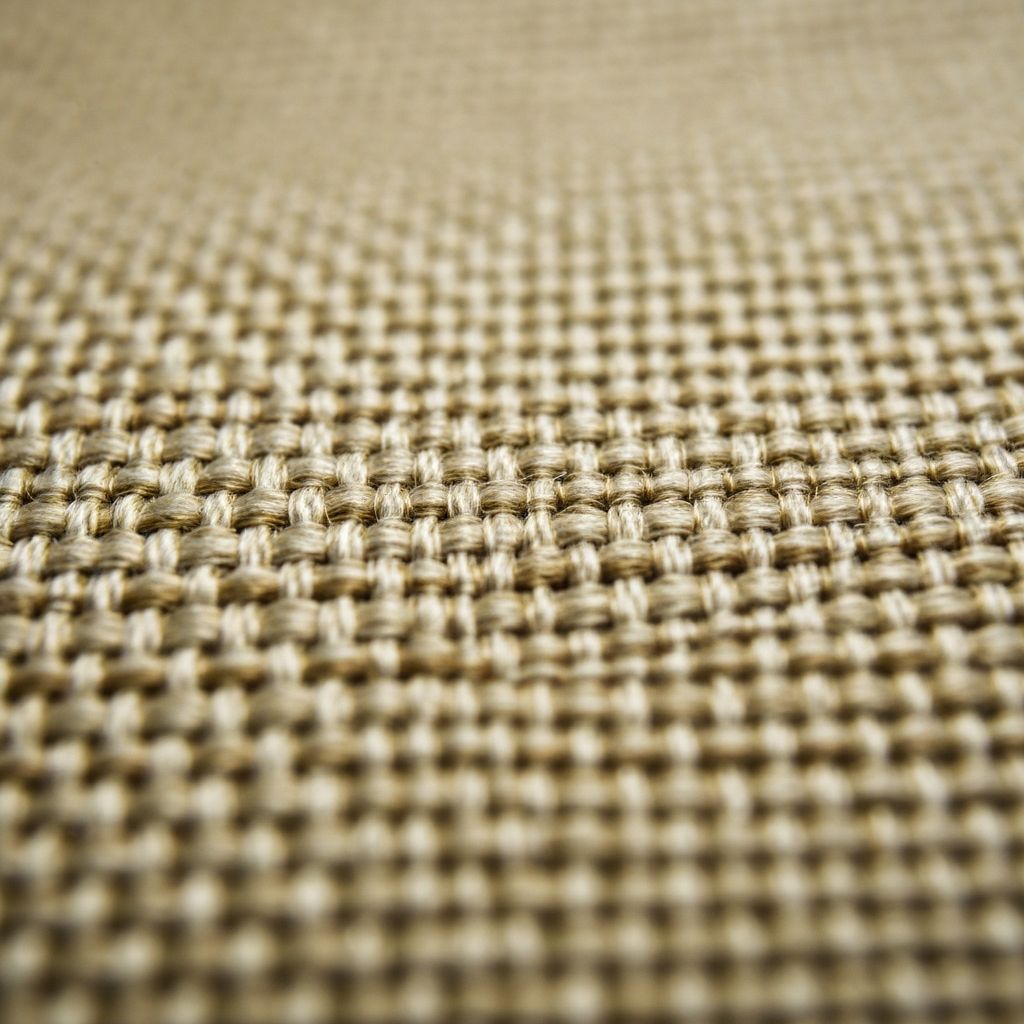 Detailed macro view of luxury fabric weave showing exceptional craftsmanship